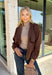 Elevate your layering game with this effortlessly chic faux suede jacket from Entro. Designed in a rich brown hue, this open-front jacket features a beautifully draped lapel that creates an elegant, flattering silhouette. The soft faux suede texture gives it a luxurious feel, while the comfortable stretch fabric makes it easy to wear from morning to night. Whether layered over dresses, blouses, or your favorite sweater, this timeless jacket is the perfect finishing touch for all your fall outfits.