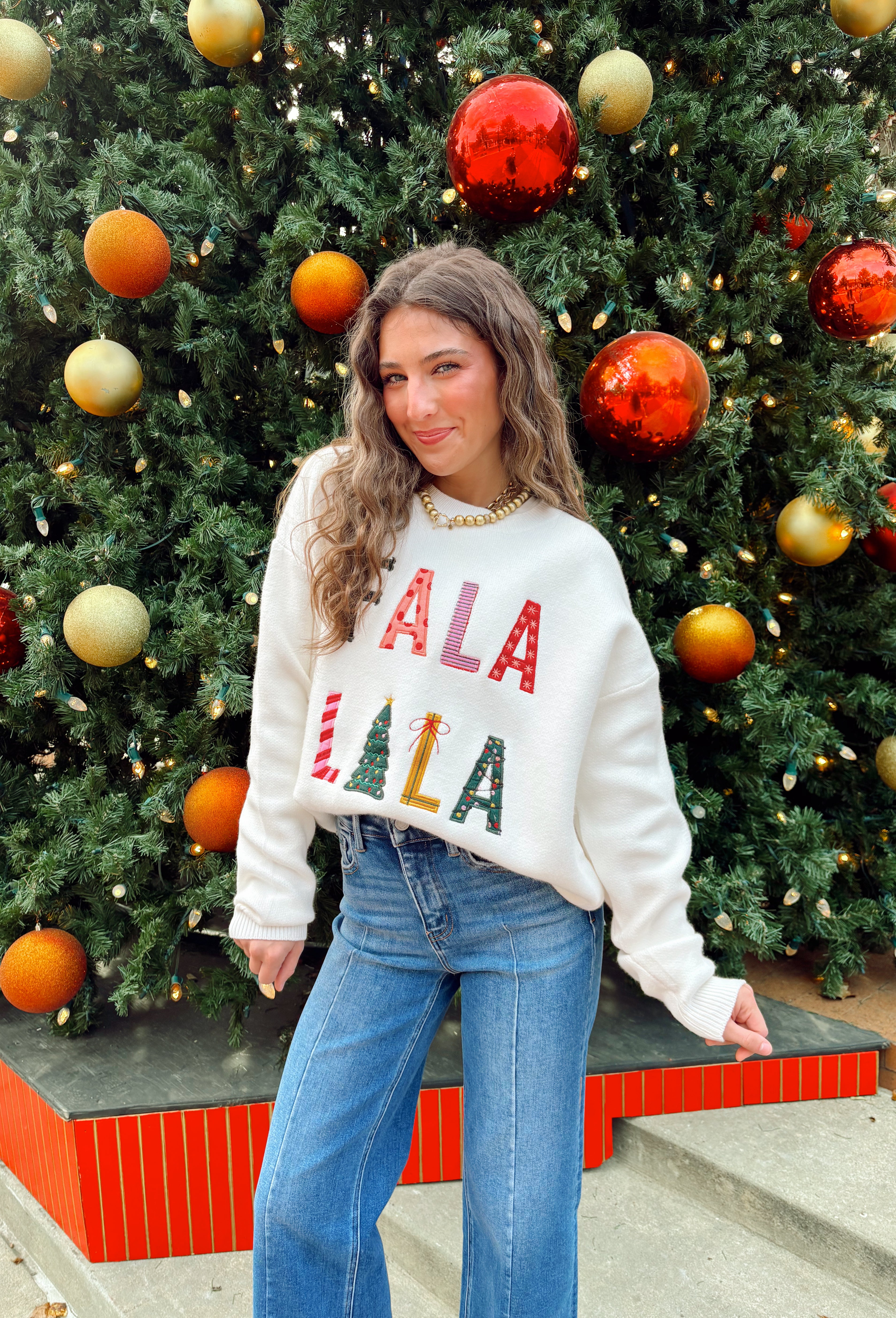 Add a playful pop of holiday cheer to your winter wardrobe with this cozy off-white sweater by Main Strip! Featuring “Fa La La La” embroidered across the front in colorful letters—each with its own fun print—this soft knit is full of festive spirit. Perfect for holiday parties, casual days, or cozy nights in, it’s the kind of merry piece you’ll wear all season long.