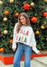 Add a playful pop of holiday cheer to your winter wardrobe with this cozy off-white sweater by Main Strip! Featuring “Fa La La La” embroidered across the front in colorful letters—each with its own fun print—this soft knit is full of festive spirit. Perfect for holiday parties, casual days, or cozy nights in, it’s the kind of merry piece you’ll wear all season long.