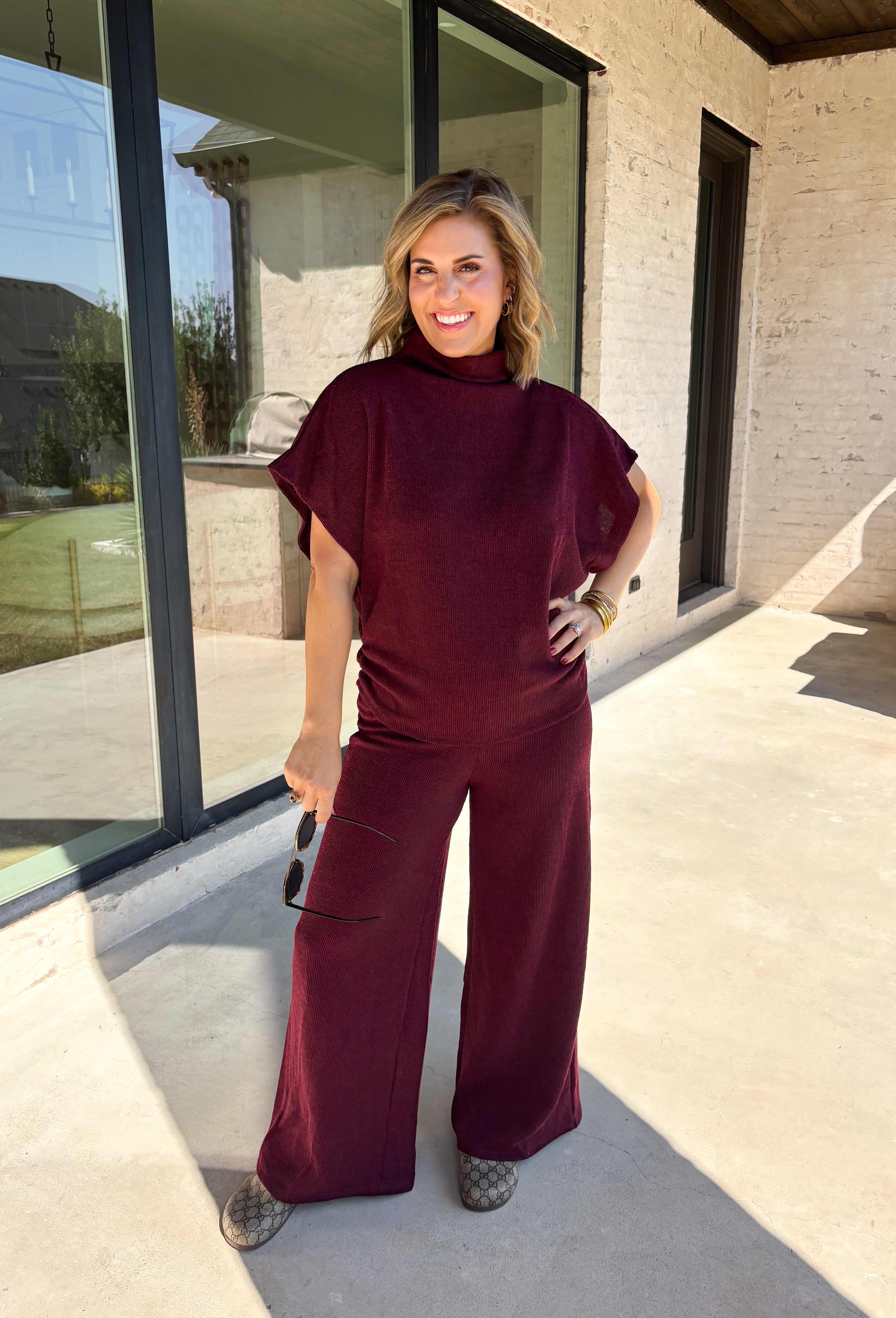 Rich burgundy makes this matching set from Hyfve an easy choice for the transition from fall gatherings into the holiday season. The short sleeve mock neck top features ruching along the sides, adding texture and shape to the simple silhouette. Matching wide leg pants keep the look comfortable with an easy elastic waistband and plenty of movement.