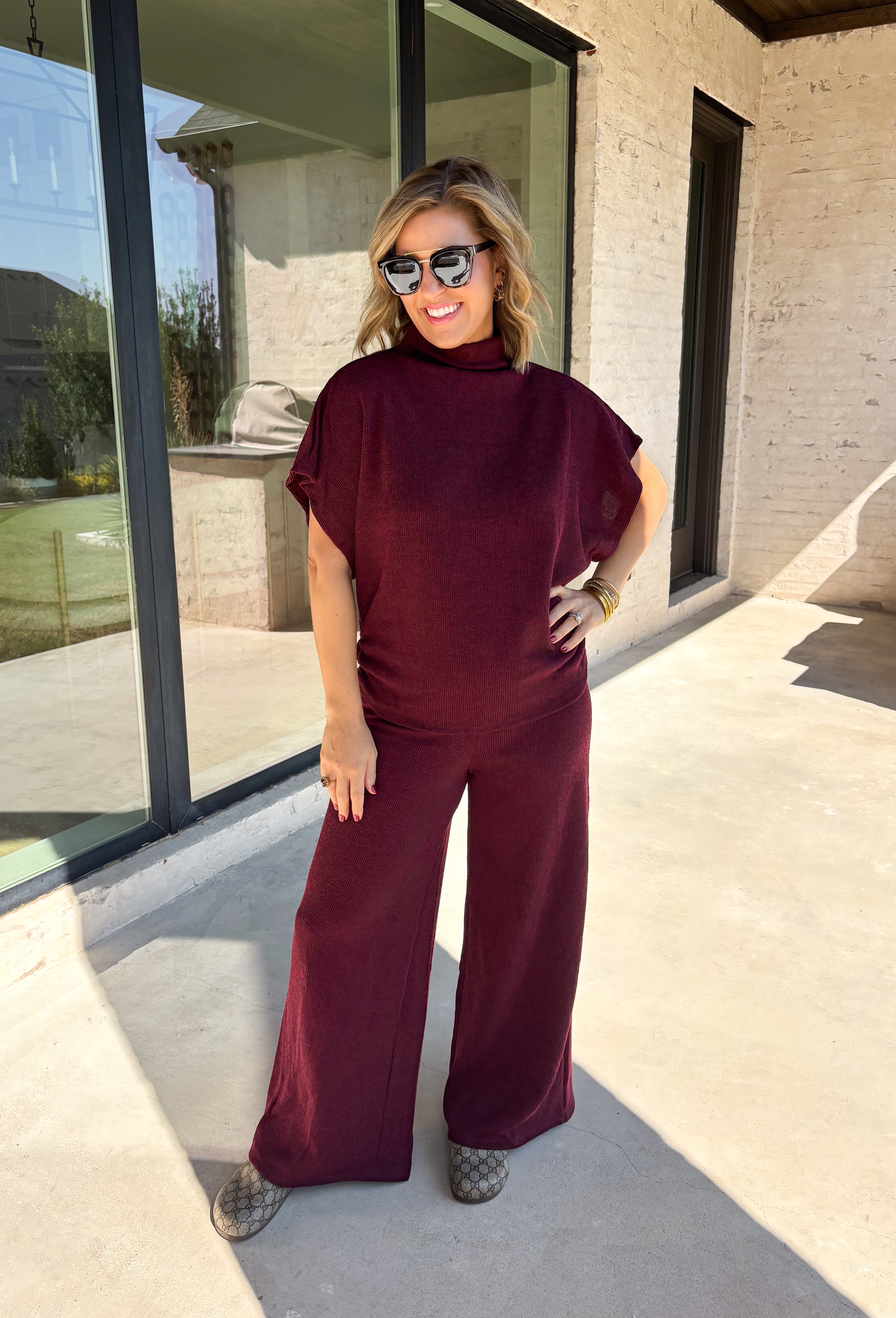 Rich burgundy makes this matching set from Hyfve an easy choice for the transition from fall gatherings into the holiday season. The short sleeve mock neck top features ruching along the sides, adding texture and shape to the simple silhouette. Matching wide leg pants keep the look comfortable with an easy elastic waistband and plenty of movement.