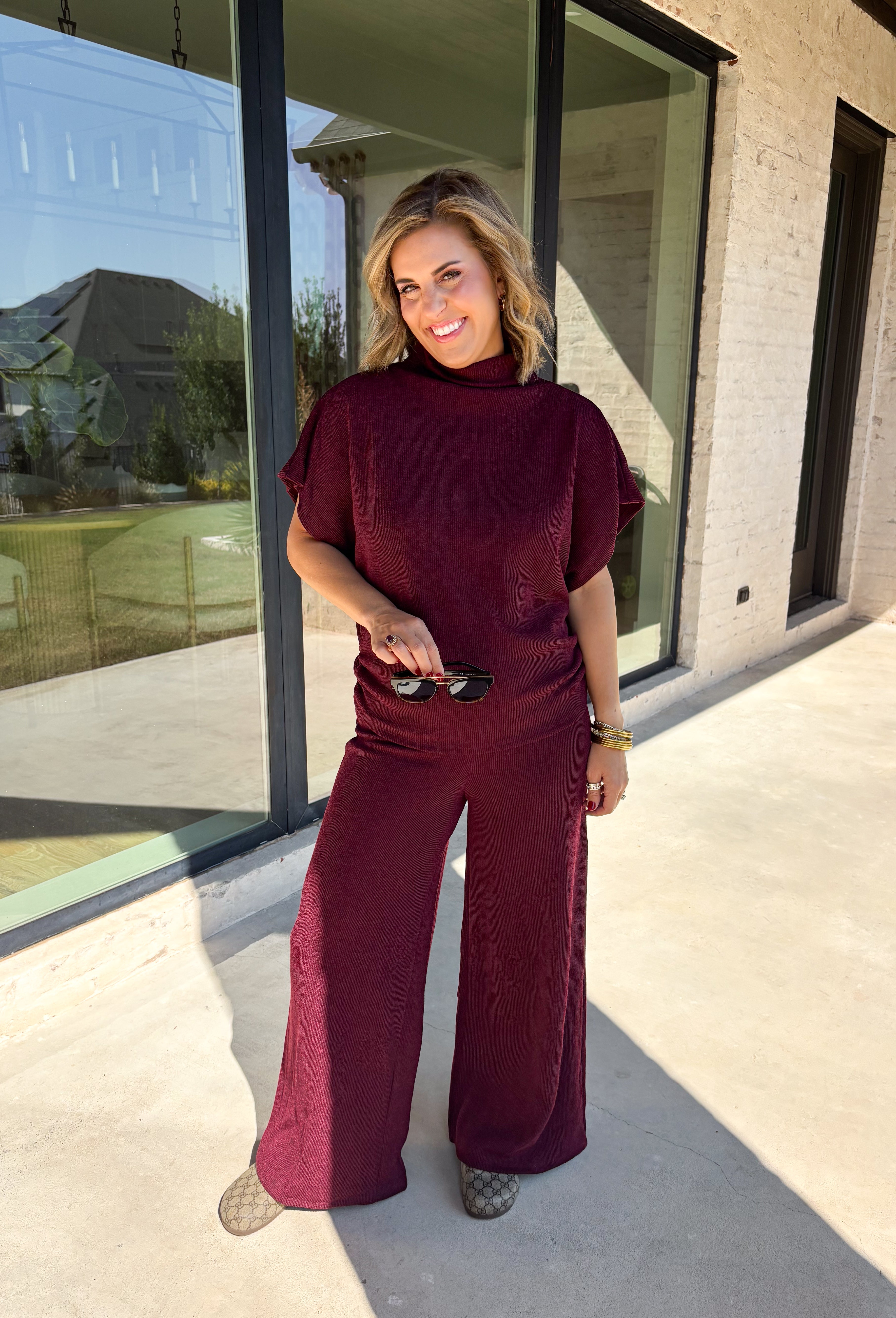 Rich burgundy makes this matching set from Hyfve an easy choice for the transition from fall gatherings into the holiday season. The short sleeve mock neck top features ruching along the sides, adding texture and shape to the simple silhouette. Matching wide leg pants keep the look comfortable with an easy elastic waistband and plenty of movement.