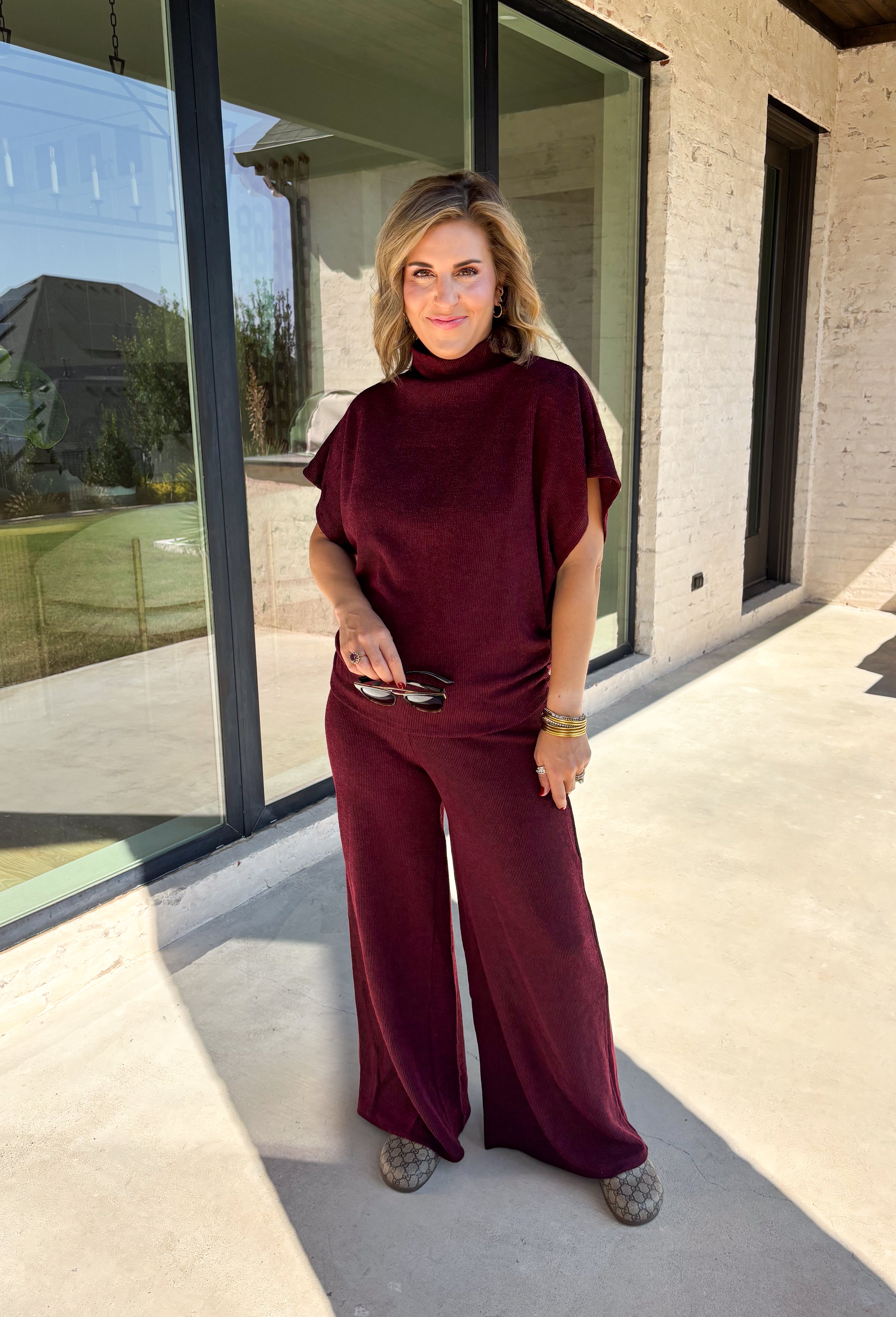 Rich burgundy makes this matching set from Hyfve an easy choice for the transition from fall gatherings into the holiday season. The short sleeve mock neck top features ruching along the sides, adding texture and shape to the simple silhouette. Matching wide leg pants keep the look comfortable with an easy elastic waistband and plenty of movement.