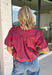 Rich autumn colors and feminine details make this striped blouse an effortless addition to your seasonal wardrobe. Featuring warm plum and rust stripes, this lightweight cotton top captures the beauty of fall while offering an easy, everyday silhouette you'll love. The banded neckline, puff sleeves, and button-front design create a polished look, while the shirring at the shoulders and back adds beautiful texture and a flattering drape. 