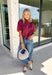 Rich autumn colors and feminine details make this striped blouse an effortless addition to your seasonal wardrobe. Featuring warm plum and rust stripes, this lightweight cotton top captures the beauty of fall while offering an easy, everyday silhouette you'll love. The banded neckline, puff sleeves, and button-front design create a polished look, while the shirring at the shoulders and back adds beautiful texture and a flattering drape. 