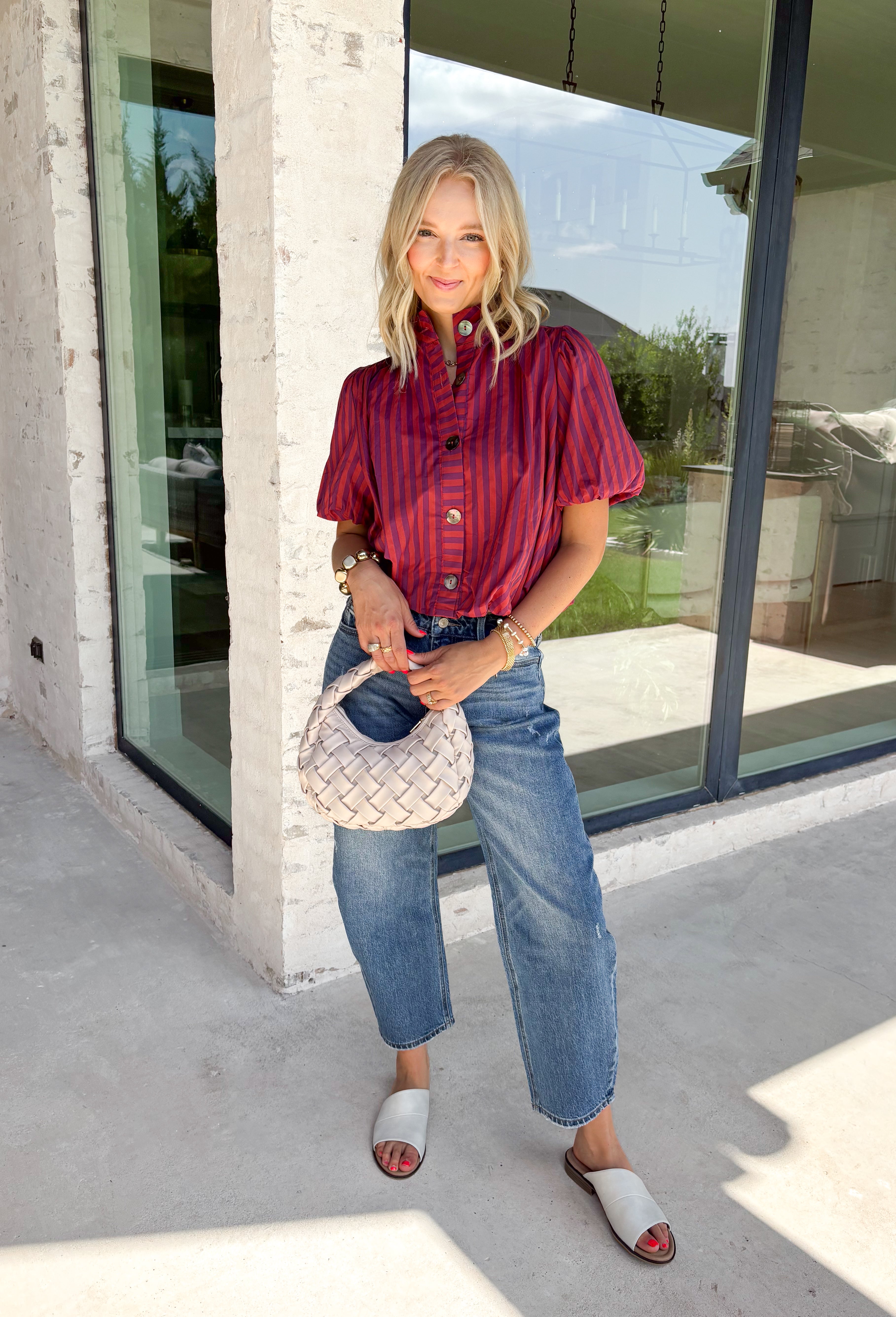 Rich autumn colors and feminine details make this striped blouse an effortless addition to your seasonal wardrobe. Featuring warm plum and rust stripes, this lightweight cotton top captures the beauty of fall while offering an easy, everyday silhouette you'll love. The banded neckline, puff sleeves, and button-front design create a polished look, while the shirring at the shoulders and back adds beautiful texture and a flattering drape. 