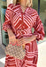 Bring effortless elegance to your fall wardrobe with this beautifully patterned midi dress from Entro. Featuring a soft light pink backdrop with a rich brown geometric print, this timeless dress offers a unique blend of feminine charm and modern style. The flattering v-neckline and removable matching belt create a customizable silhouette, while the long balloon sleeves with button cuffs add graceful movement and sophistication. 