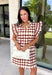 Bring playful charm to your fall wardrobe with this beautiful dress from THML. Designed in a rich burgundy hue with a bold neutral polka dot print, this timeless piece is perfect for everything from brunch dates to seasonal celebrations. The ruffle sleeves are finished with delicate smocking for an extra feminine touch, while the fully lined silhouette offers all-day comfort. Complete with convenient side pockets, this cotton dress is one you'll love reaching for throughout the season.