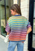Who says fall has to be all neutrals? This cozy knit cardigan brings a cheerful burst of color to your seasonal wardrobe with bold stripes in green, pink, purple, yellow, blue, and orange. The button-down design gives you endless styling options—wear it buttoned as a sweater or open over your favorite basics for an effortless layered look. Crafted from a soft, cozy knit, it's the perfect piece to brighten crisp autumn days while keeping you comfortable from morning coffee runs to weekend adventures.