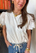Your favorite everyday white tee just got the prettiest little upgrade. This white short sleeve top by Doe and Rae features delicate eyelet sleeves that instantly elevate a classic silhouette. It’s the perfect blend of casual comfort and feminine detail — easy enough for daily wear, but polished enough to dress up. Made from breathable 100% cotton, this elevated t-shirt keeps you cool and comfortable all season long. 