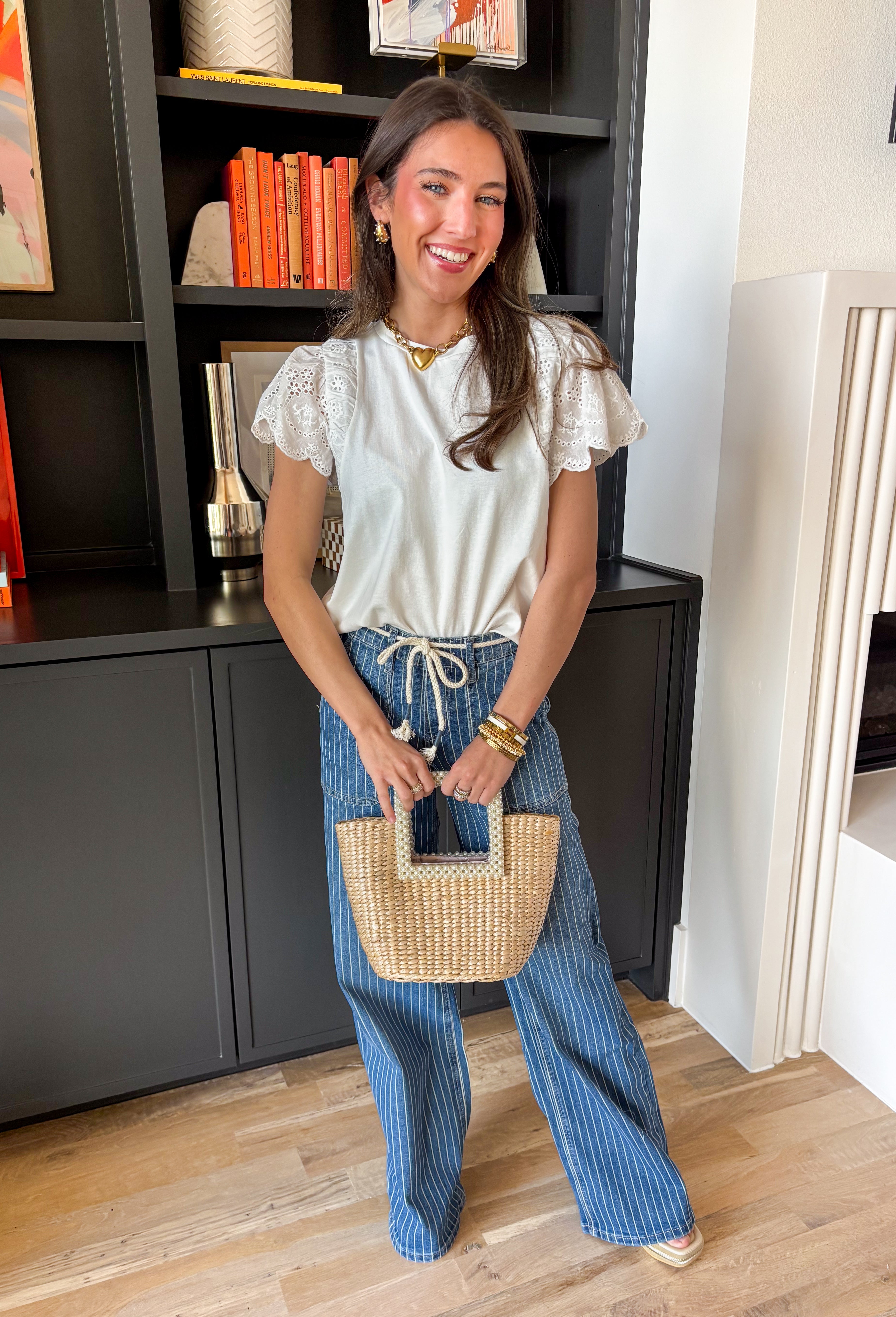 Your favorite everyday white tee just got the prettiest little upgrade. This white short sleeve top by Doe and Rae features delicate eyelet sleeves that instantly elevate a classic silhouette. It’s the perfect blend of casual comfort and feminine detail — easy enough for daily wear, but polished enough to dress up. Made from breathable 100% cotton, this elevated t-shirt keeps you cool and comfortable all season long. 