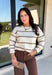 Wrap yourself in cozy comfort with this timeless sweater from Hyfve. Designed in a soft oatmeal knit, this effortlessly stylish sweater features a vintage-inspired stripe pattern in warm shades of tan and brown for the perfect touch of seasonal charm. The relaxed silhouette and soft knit make it an easy piece to throw on for crisp fall days, while the classic design ensures you'll wear it year after year. 