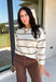 Wrap yourself in cozy comfort with this timeless sweater from Hyfve. Designed in a soft oatmeal knit, this effortlessly stylish sweater features a vintage-inspired stripe pattern in warm shades of tan and brown for the perfect touch of seasonal charm. The relaxed silhouette and soft knit make it an easy piece to throw on for crisp fall days, while the classic design ensures you'll wear it year after year. 