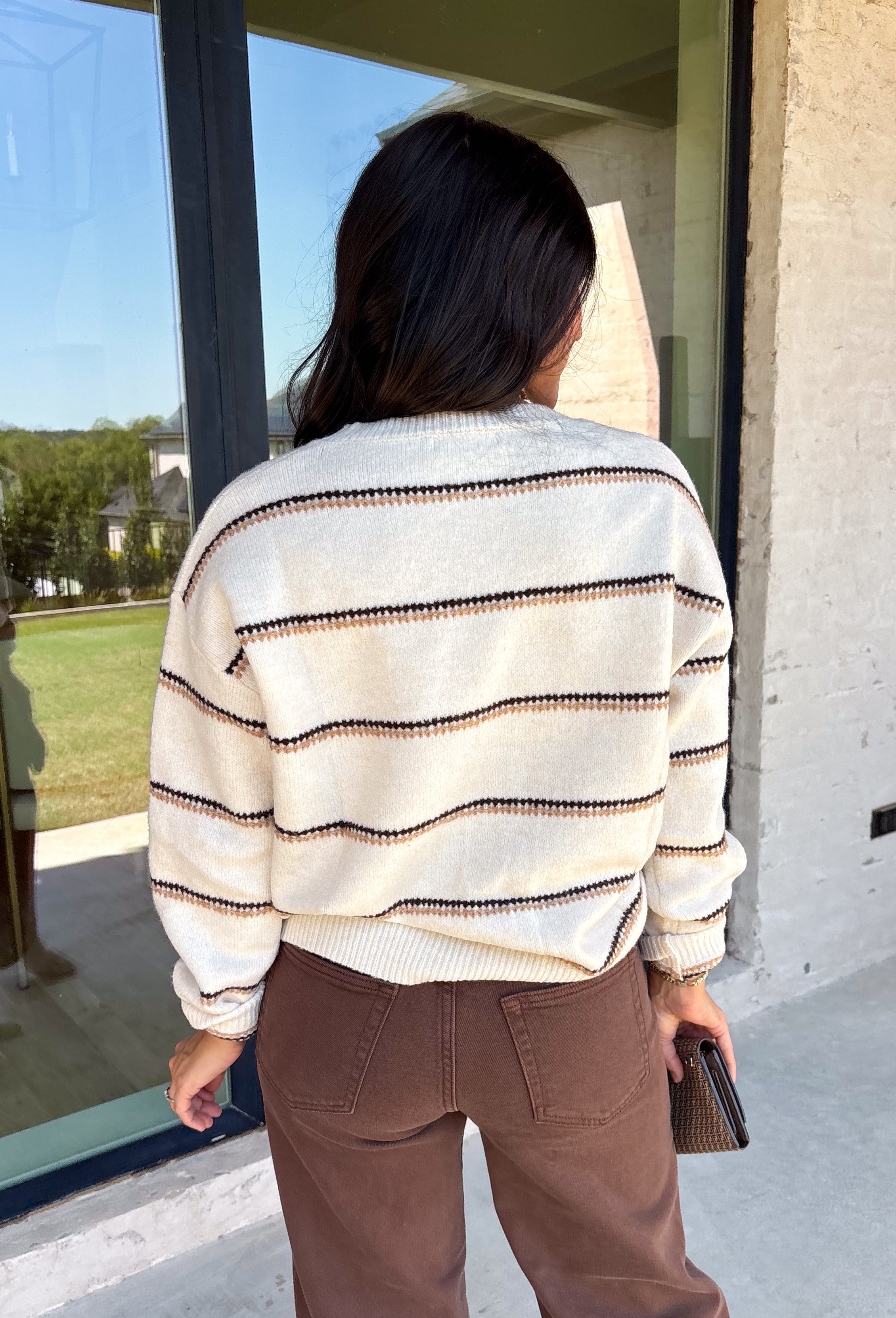 Wrap yourself in cozy comfort with this timeless sweater from Hyfve. Designed in a soft oatmeal knit, this effortlessly stylish sweater features a vintage-inspired stripe pattern in warm shades of tan and brown for the perfect touch of seasonal charm. The relaxed silhouette and soft knit make it an easy piece to throw on for crisp fall days, while the classic design ensures you'll wear it year after year. 