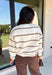 Wrap yourself in cozy comfort with this timeless sweater from Hyfve. Designed in a soft oatmeal knit, this effortlessly stylish sweater features a vintage-inspired stripe pattern in warm shades of tan and brown for the perfect touch of seasonal charm. The relaxed silhouette and soft knit make it an easy piece to throw on for crisp fall days, while the classic design ensures you'll wear it year after year. 