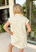 This ecru polka dot dress is the kind of timeless piece you'll reach for all season long! The classic black polka dot print gives it a sophisticated, vintage-inspired feel, while the collared neckline and button down design keep it effortlessly polished. Front and side pockets add the perfect blend of style and function, and the cuffed sleeves give it that easy, relaxed finish. Made from breathable cotton, it's perfect for transitioning into fall with sneakers now and boots later.