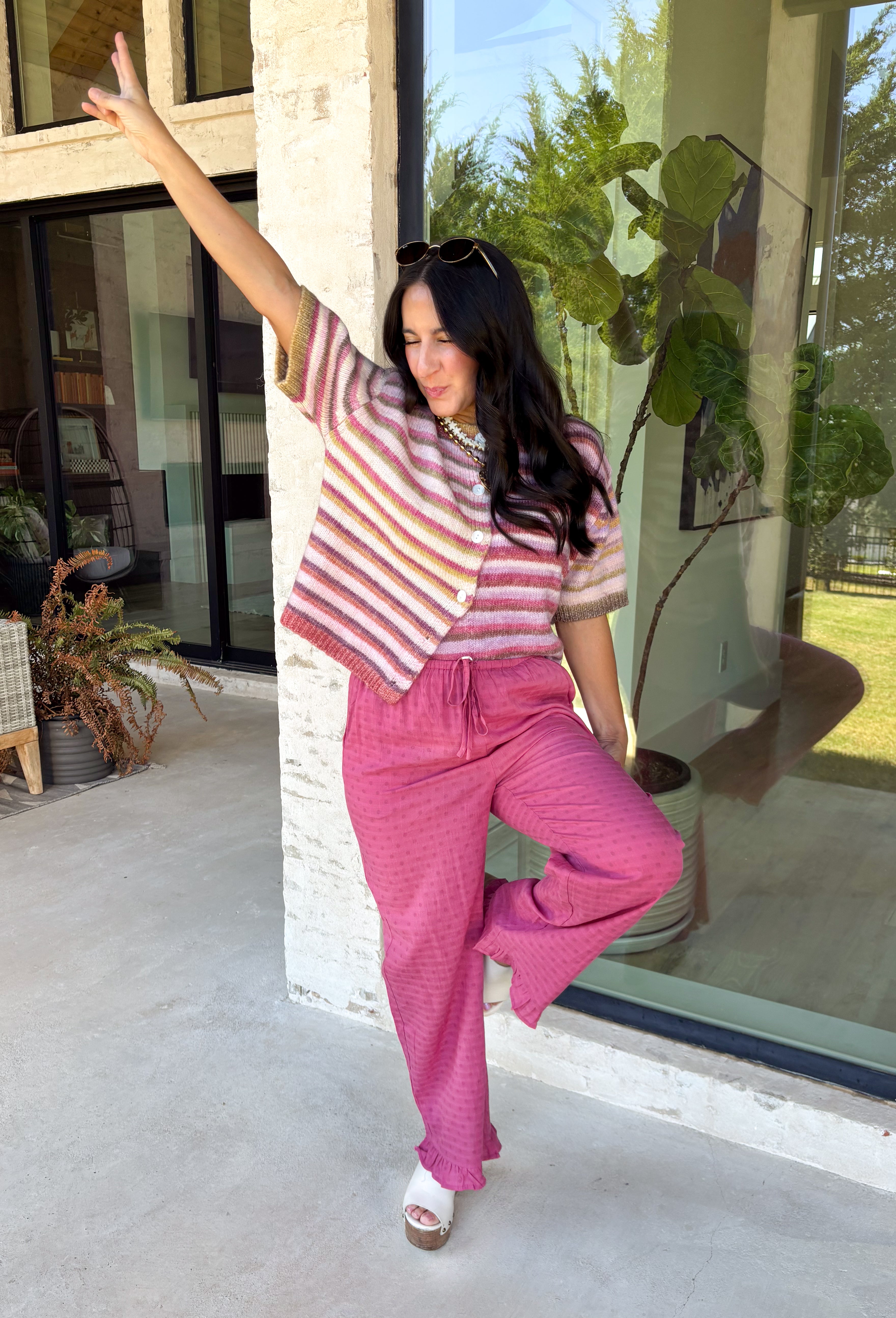 Who says fall has to be all neutrals? This cozy knit cardigan brings a cheerful burst of color to your seasonal wardrobe with bold stripes in shades of berries. The button-down design gives you endless styling options—wear it buttoned as a sweater or open over your favorite basics for an effortless layered look. Crafted from a soft, cozy knit, it's the perfect piece to brighten crisp autumn days while keeping you comfortable from morning coffee runs to weekend adventures.