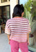 Who says fall has to be all neutrals? This cozy knit cardigan brings a cheerful burst of color to your seasonal wardrobe with bold stripes in shades of berries. The button-down design gives you endless styling options—wear it buttoned as a sweater or open over your favorite basics for an effortless layered look. Crafted from a soft, cozy knit, it's the perfect piece to brighten crisp autumn days while keeping you comfortable from morning coffee runs to weekend adventures.