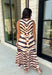 Turn heads this season in a midi dress that's equal parts bold and timeless. Featuring a neutral backdrop with an eye-catching black and orange tiger stripe print, this dress makes a statement while remaining effortlessly wearable. The belted waist creates a flattering silhouette, while side pockets and a fully lined design add comfort and practicality. Whether you're headed to brunch, family photos, or a fall event, this standout dress is ready for every occasion on your calendar.