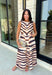 Turn heads this season in a midi dress that's equal parts bold and timeless. Featuring a neutral backdrop with an eye-catching black and orange tiger stripe print, this dress makes a statement while remaining effortlessly wearable. The belted waist creates a flattering silhouette, while side pockets and a fully lined design add comfort and practicality. Whether you're headed to brunch, family photos, or a fall event, this standout dress is ready for every occasion on your calendar.