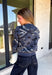 Add a touch of western-inspired charm to your fall wardrobe with this beautifully detailed cardigan from Sunday Edition. Designed in a soft dusty blue knit, this cozy button-down sweater features a vintage-inspired bandana print with cream and black floral and western detailing for a look that's both timeless and unique. Ribbed trim along the neckline, cuffs, and hem creates a polished finish, while the soft knit blend makes it the perfect layering piece for crisp autumn days.