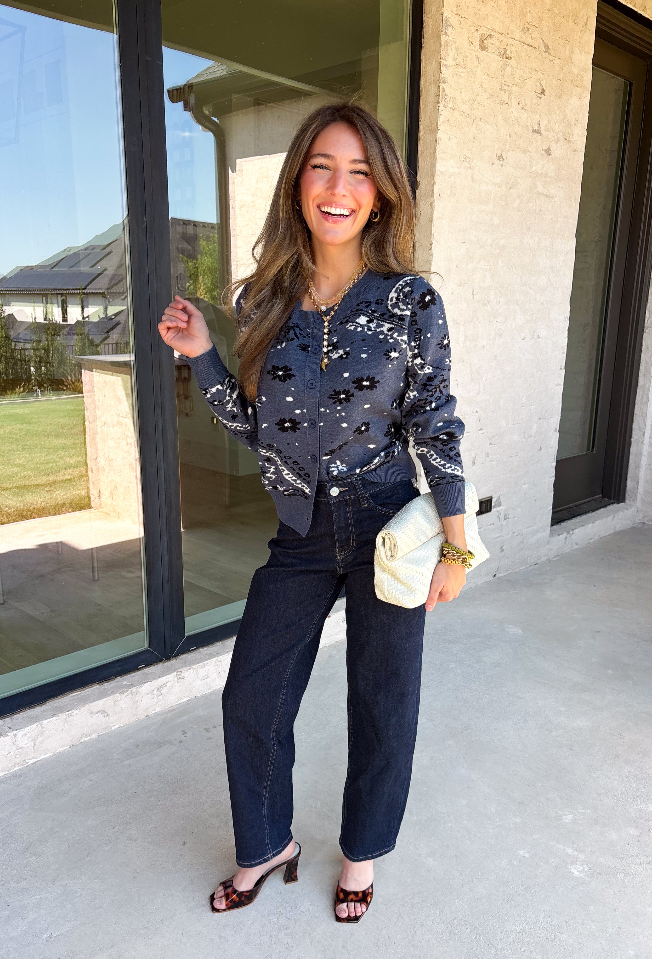 Add a touch of western-inspired charm to your fall wardrobe with this beautifully detailed cardigan from Sunday Edition. Designed in a soft dusty blue knit, this cozy button-down sweater features a vintage-inspired bandana print with cream and black floral and western detailing for a look that's both timeless and unique. Ribbed trim along the neckline, cuffs, and hem creates a polished finish, while the soft knit blend makes it the perfect layering piece for crisp autumn days.