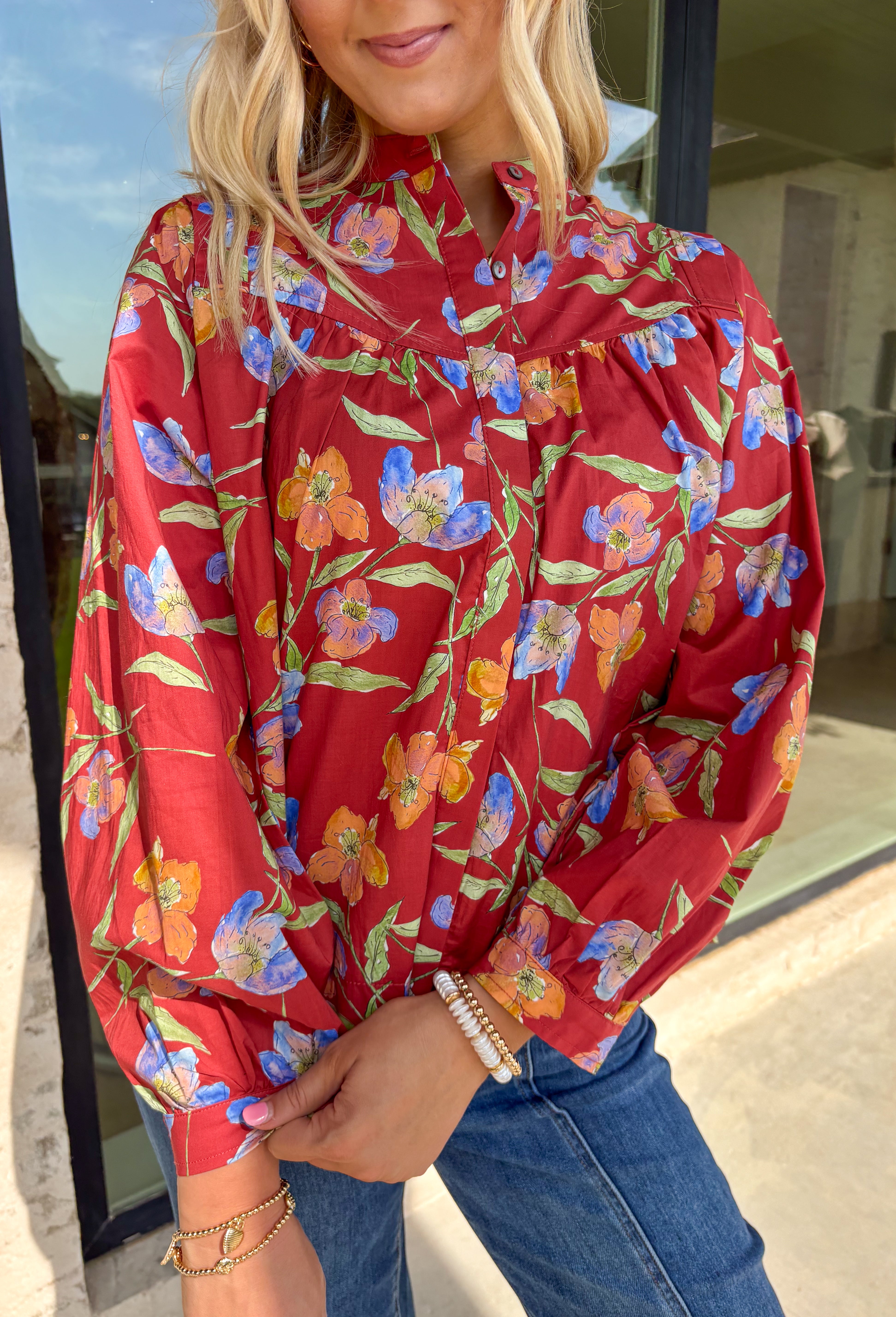 This autumn-ready floral blouse brings all the charm of the season in one lightweight layer. With its rich botanical print and crisp collar, this top feels timeless but with an elevated twist thanks to the hidden button placket and cuff band long sleeves. It’s a closet staple you'll be reaching for from pumpkin spice runs to Thanksgiving dinner.