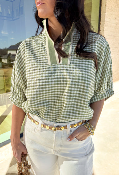Sweet, fresh, and made for spring, this matcha and off-white gingham top by Entro is the perfect everyday pick-me-up. The gingham print gives it that classic, picnic-ready vibe, while the cream and matcha band along the top adds a clean contrast detail that makes it feel extra polished. Finished with elastic cuff sleeves for a comfortable fit, this top is lightweight, easy to style, and cute enough to wear on repeat all season long.