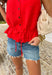 Add a pop of bold spring color to your closet with this red button down sweater tank by Wishlist! The open knit texture keeps it light and breathable, while the button-front design makes it easy to style solo or layered over a simple cami. Finished with the cutest scalloped hem and a tie detail at the bottom, this piece gives you that “effortlessly put together” look with just the right amount of playful charm. Pair it with light wash denim for an easy daytime outfit.