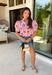 Nothing says sweet spring style quite like red and white stripes paired with cheerful florals. This striped short puff sleeve top by Entro brings playful charm and feminine detail together in the prettiest way. The classic red and white stripe base is brightened up with pink, red, green, and blue floral embroidery that adds texture, color, and that extra-special touch. Designed with a flattering button-front closure and soft puff sleeves, this top feels polished yet easy to wear. 