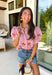 Nothing says sweet spring style quite like red and white stripes paired with cheerful florals. This striped short puff sleeve top by Entro brings playful charm and feminine detail together in the prettiest way. The classic red and white stripe base is brightened up with pink, red, green, and blue floral embroidery that adds texture, color, and that extra-special touch. Designed with a flattering button-front closure and soft puff sleeves, this top feels polished yet easy to wear. 