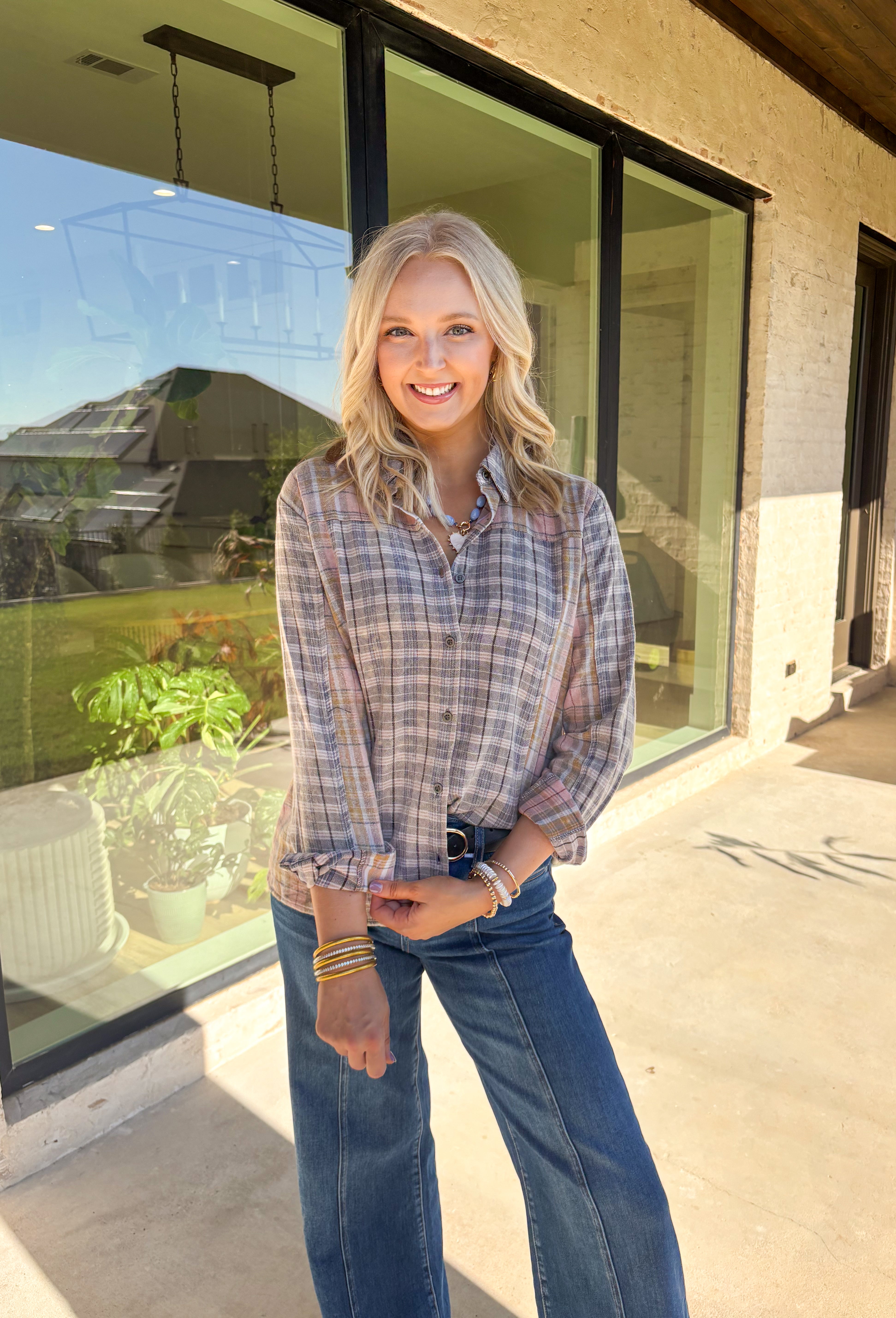 A timeless favorite with a cozy fall twist—this plaid flannel by Mystree is as versatile as it is comfortable. Designed in a mix of neutral shades with subtle pops of gray, light pink, light blue, tan, and off-white, it’s easy to pair with just about anything in your closet. The button-down design and collared neckline keep it classic, while the 100% cotton fabric makes it breathable and soft for all-day wear. Perfect for layering or styling solo, this flannel will be your go-to through the season.