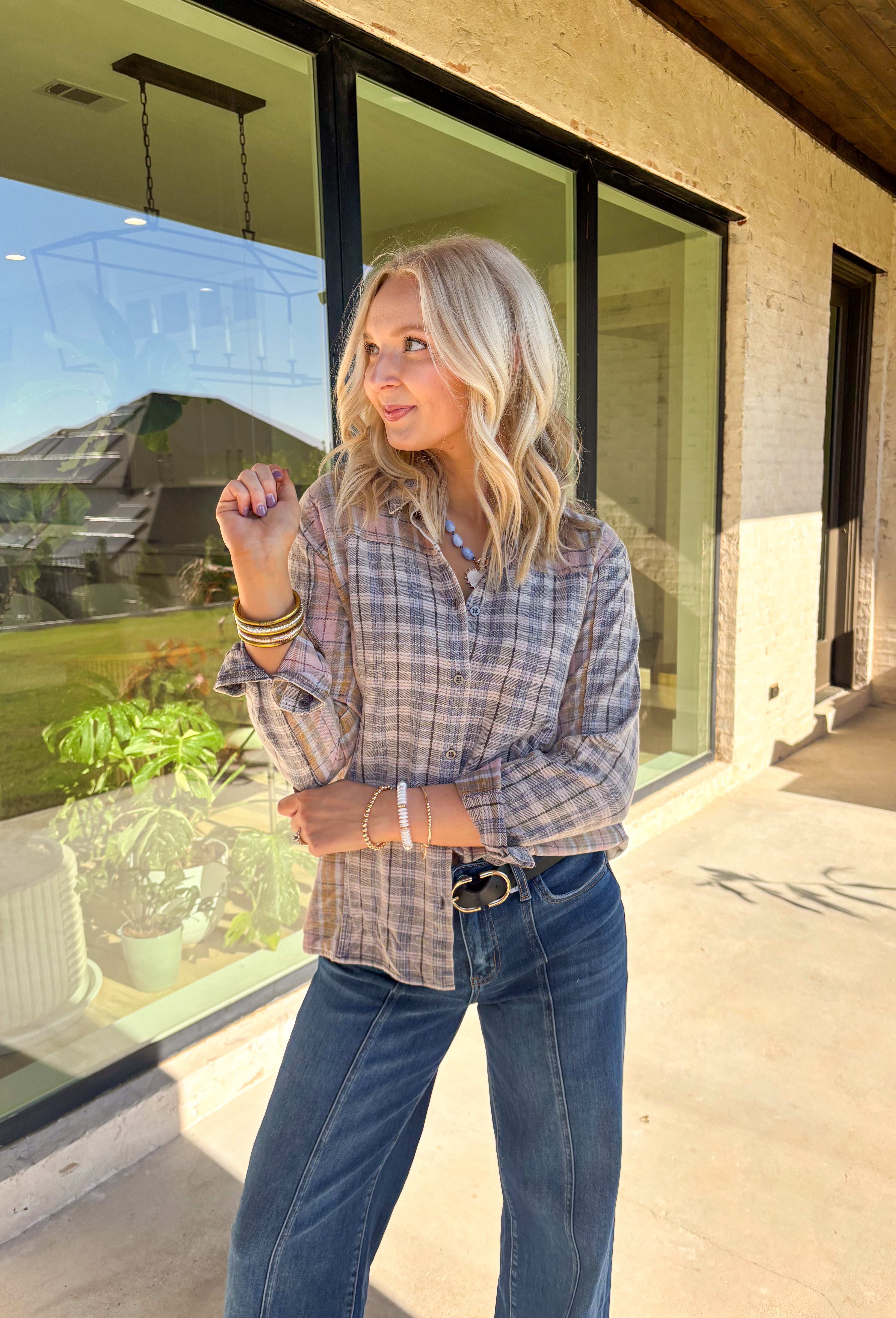A timeless favorite with a cozy fall twist—this plaid flannel by Mystree is as versatile as it is comfortable. Designed in a mix of neutral shades with subtle pops of gray, light pink, light blue, tan, and off-white, it’s easy to pair with just about anything in your closet. The button-down design and collared neckline keep it classic, while the 100% cotton fabric makes it breathable and soft for all-day wear. Perfect for layering or styling solo, this flannel will be your go-to through the season.