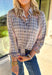 A timeless favorite with a cozy fall twist—this plaid flannel by Mystree is as versatile as it is comfortable. Designed in a mix of neutral shades with subtle pops of gray, light pink, light blue, tan, and off-white, it’s easy to pair with just about anything in your closet. The button-down design and collared neckline keep it classic, while the 100% cotton fabric makes it breathable and soft for all-day wear. Perfect for layering or styling solo, this flannel will be your go-to through the season.
