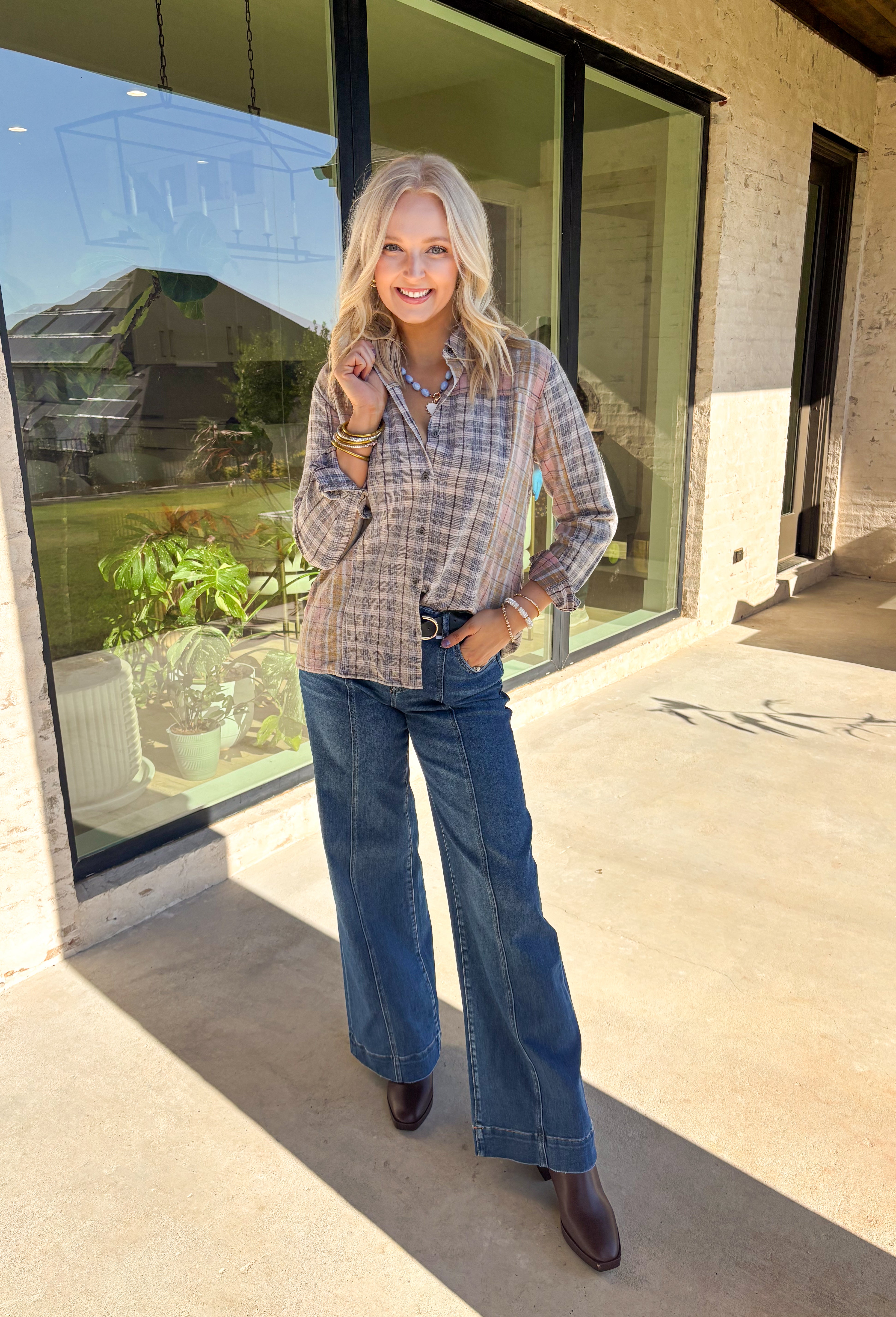 A timeless favorite with a cozy fall twist—this plaid flannel by Mystree is as versatile as it is comfortable. Designed in a mix of neutral shades with subtle pops of gray, light pink, light blue, tan, and off-white, it’s easy to pair with just about anything in your closet. The button-down design and collared neckline keep it classic, while the 100% cotton fabric makes it breathable and soft for all-day wear. Perfect for layering or styling solo, this flannel will be your go-to through the season.