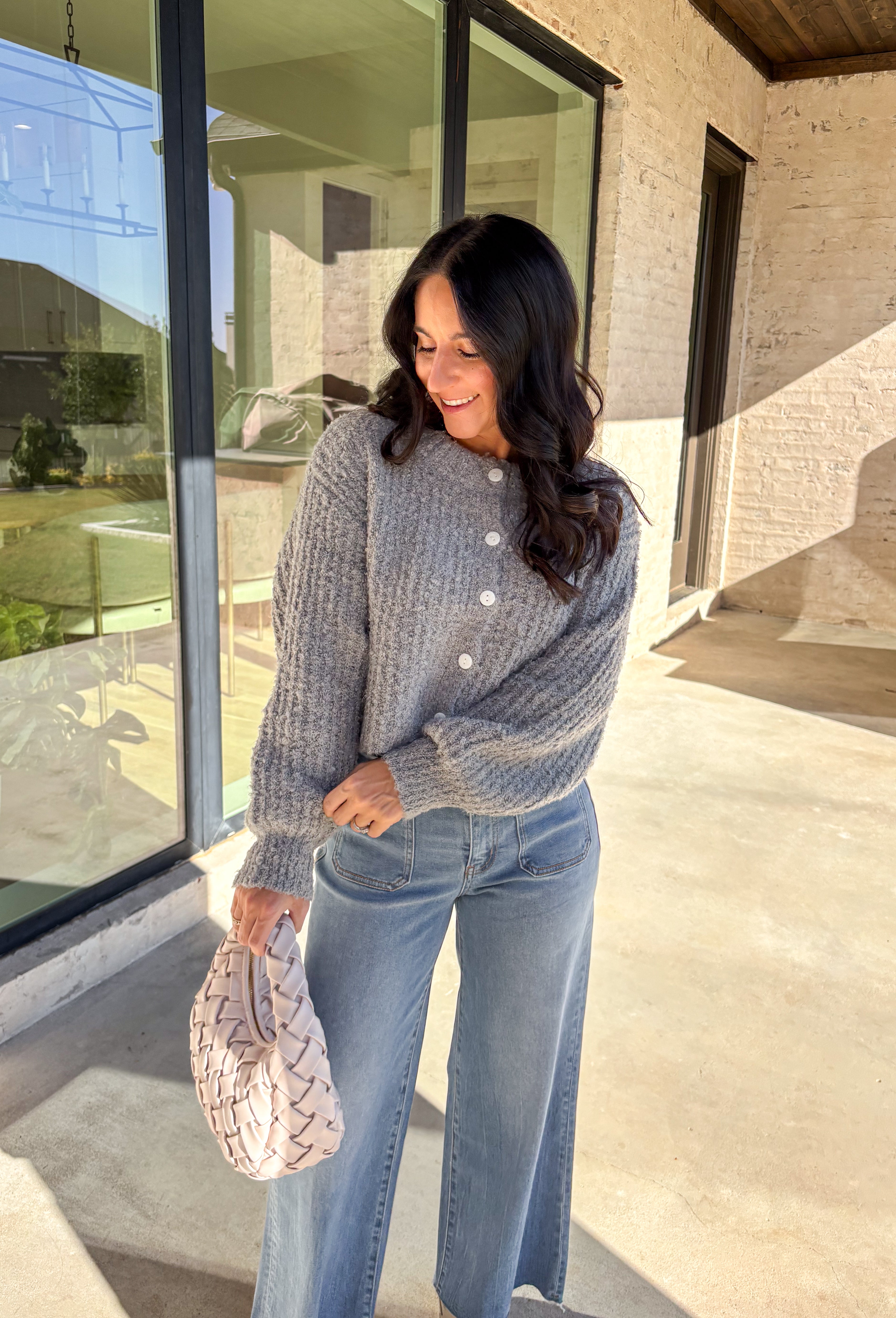 Soft, cozy, and perfectly cropped—this heather gray cardigan by Double Zero is a closet must-have for the season. The button-down front and relaxed fit make it effortlessly versatile, while the ultra-soft fabric keeps it comfy for all-day wear. Ideal for layering over your favorite tanks or pairing with high-rise denim, this cozy cutie is ready for fall days and nights in.