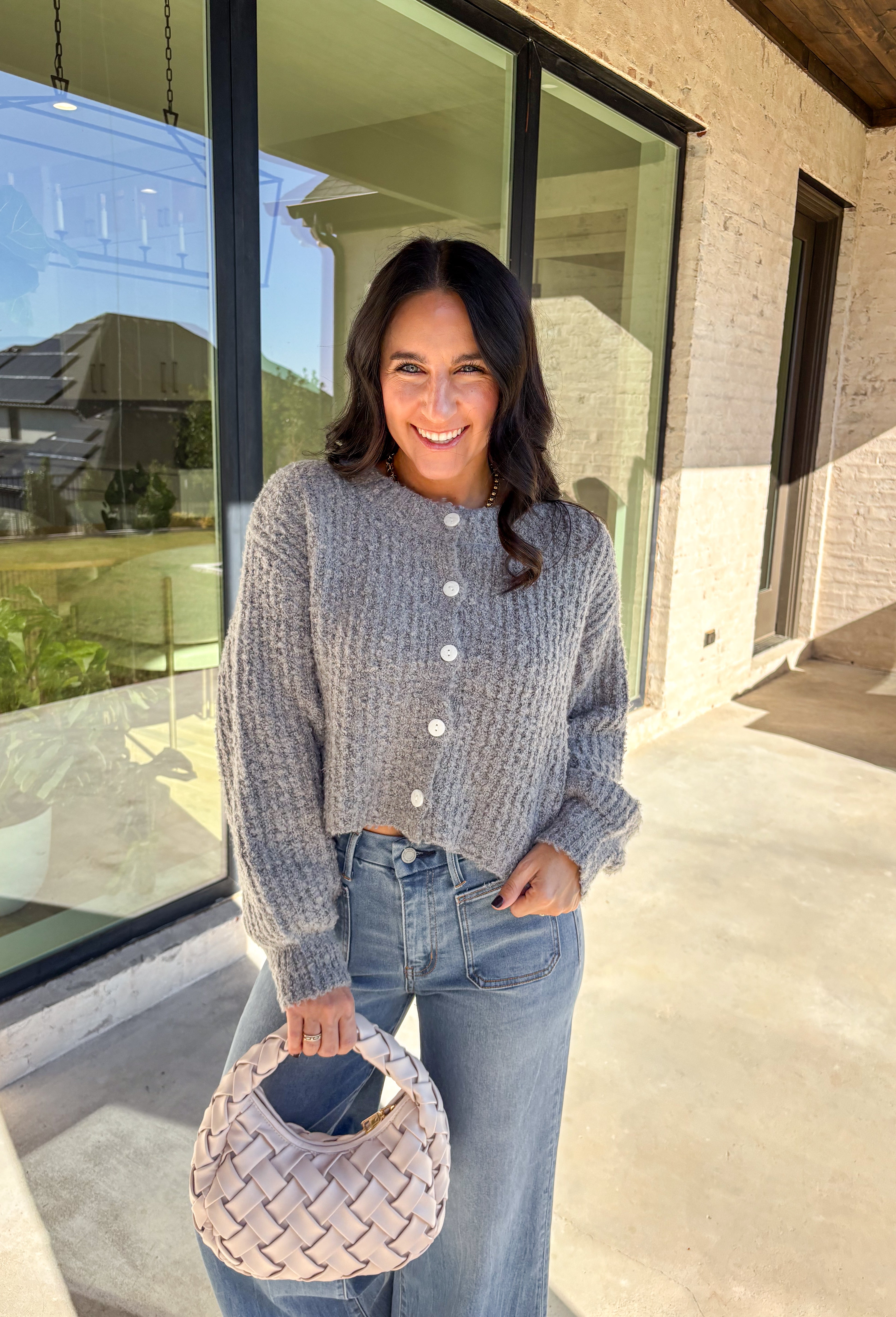 Soft, cozy, and perfectly cropped—this heather gray cardigan by Double Zero is a closet must-have for the season. The button-down front and relaxed fit make it effortlessly versatile, while the ultra-soft fabric keeps it comfy for all-day wear. Ideal for layering over your favorite tanks or pairing with high-rise denim, this cozy cutie is ready for fall days and nights in.