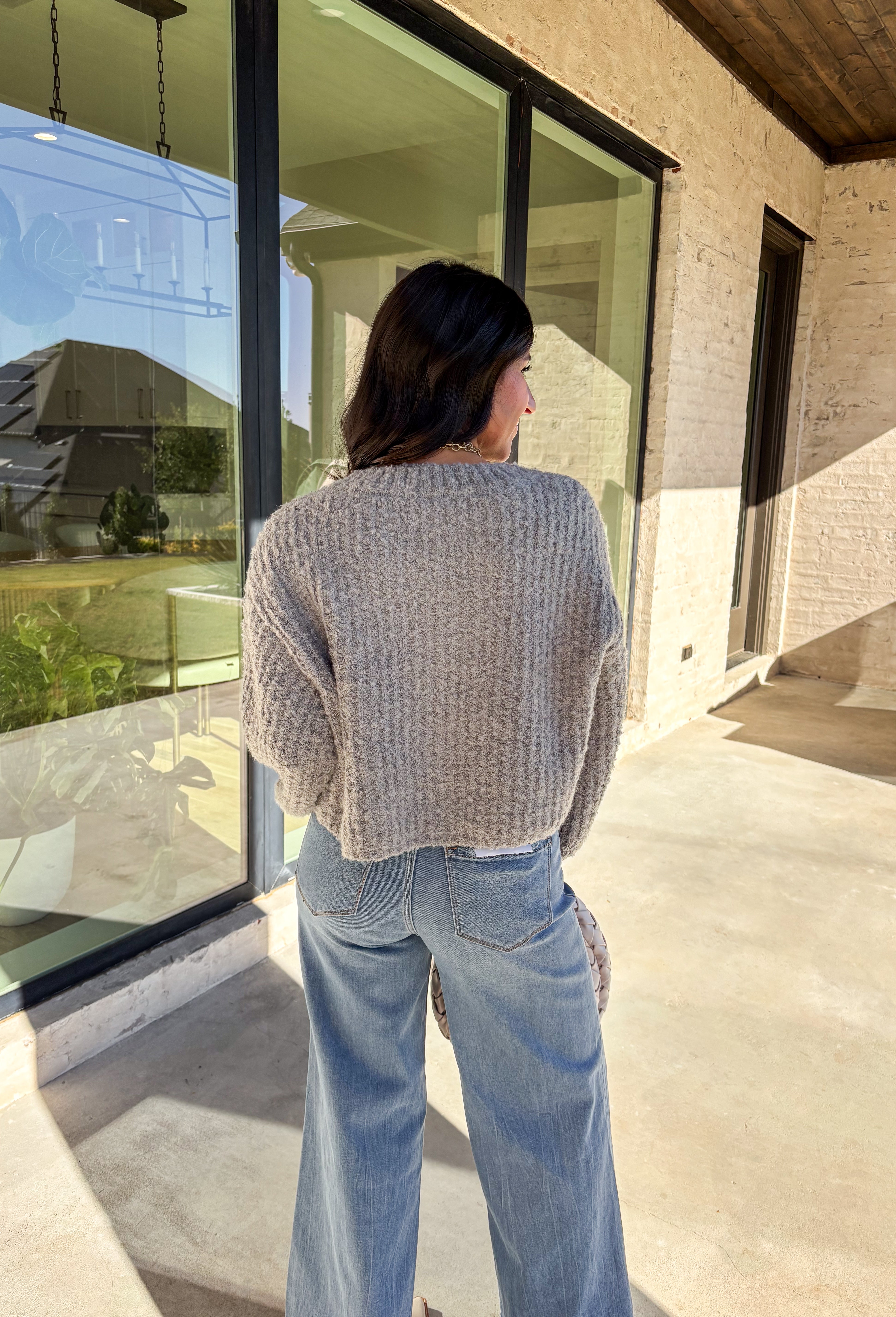 Soft, cozy, and perfectly cropped—this heather gray cardigan by Double Zero is a closet must-have for the season. The button-down front and relaxed fit make it effortlessly versatile, while the ultra-soft fabric keeps it comfy for all-day wear. Ideal for layering over your favorite tanks or pairing with high-rise denim, this cozy cutie is ready for fall days and nights in.