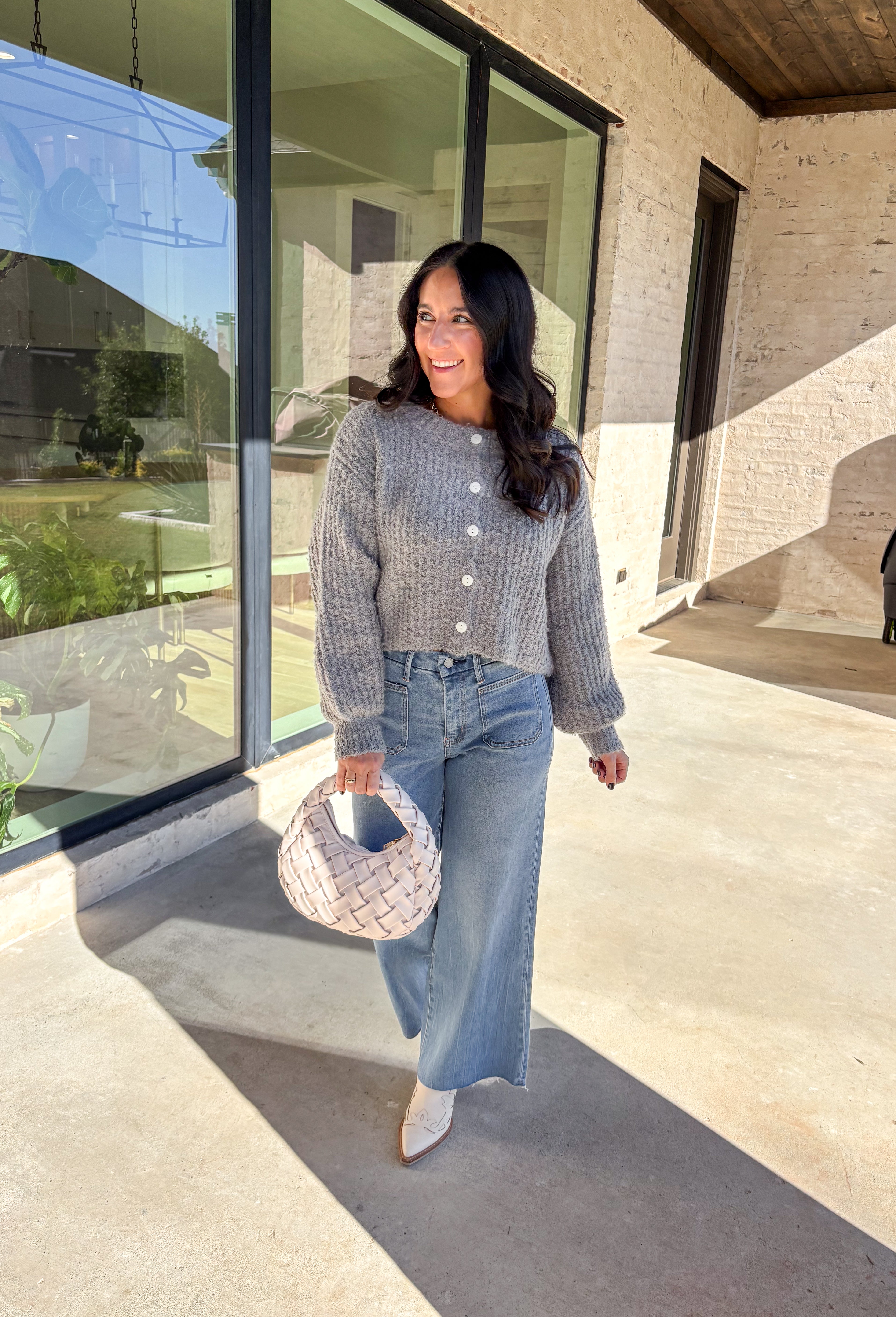 Soft, cozy, and perfectly cropped—this heather gray cardigan by Double Zero is a closet must-have for the season. The button-down front and relaxed fit make it effortlessly versatile, while the ultra-soft fabric keeps it comfy for all-day wear. Ideal for layering over your favorite tanks or pairing with high-rise denim, this cozy cutie is ready for fall days and nights in.