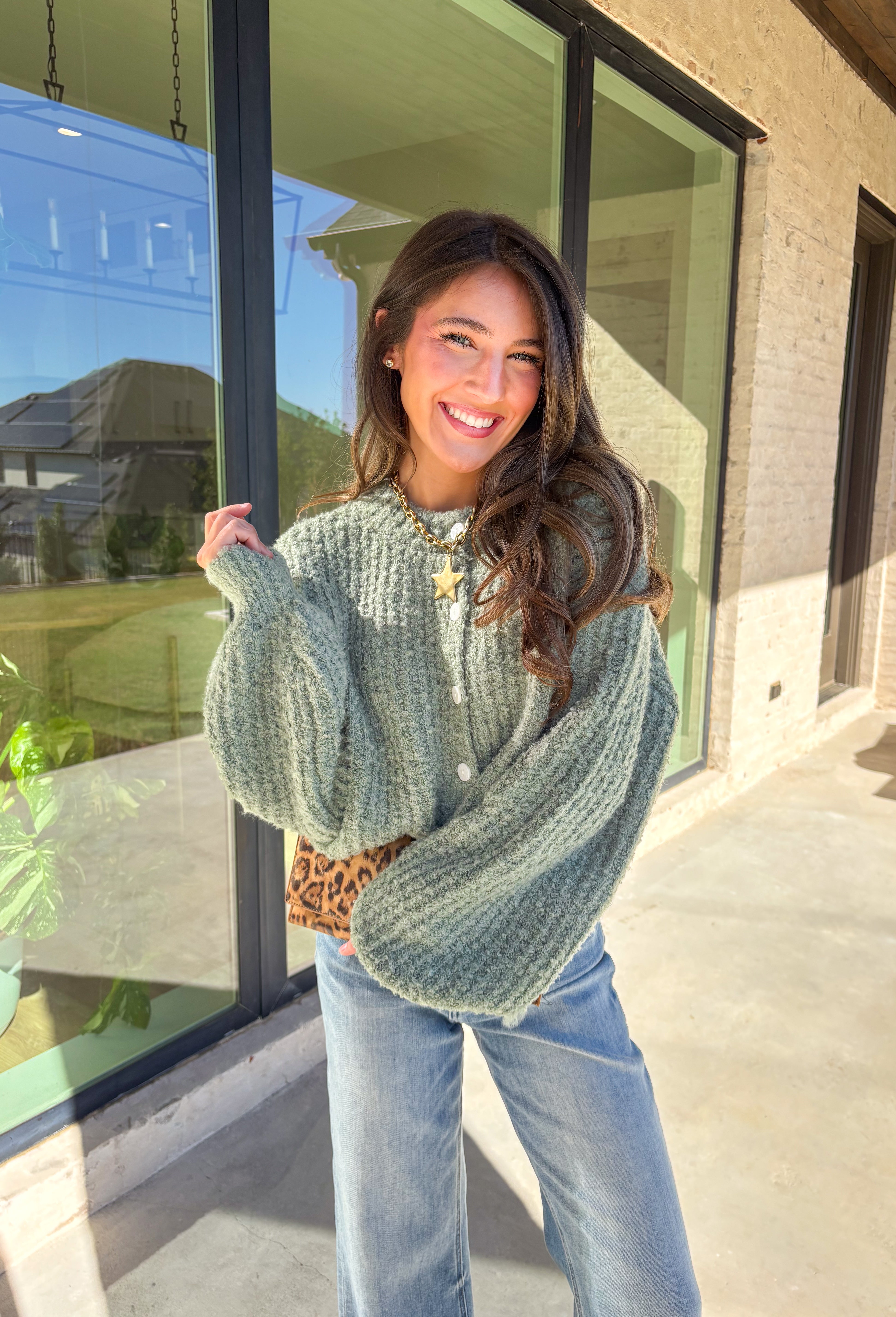 Soft, cozy, and perfectly cropped—this sage green cardigan by Double Zero is a closet must-have for the season. The button-down front and relaxed fit make it effortlessly versatile, while the ultra-soft fabric keeps it comfy for all-day wear. Ideal for layering over your favorite tanks or pairing with high-rise denim, this cozy cutie is ready for fall days and nights in.