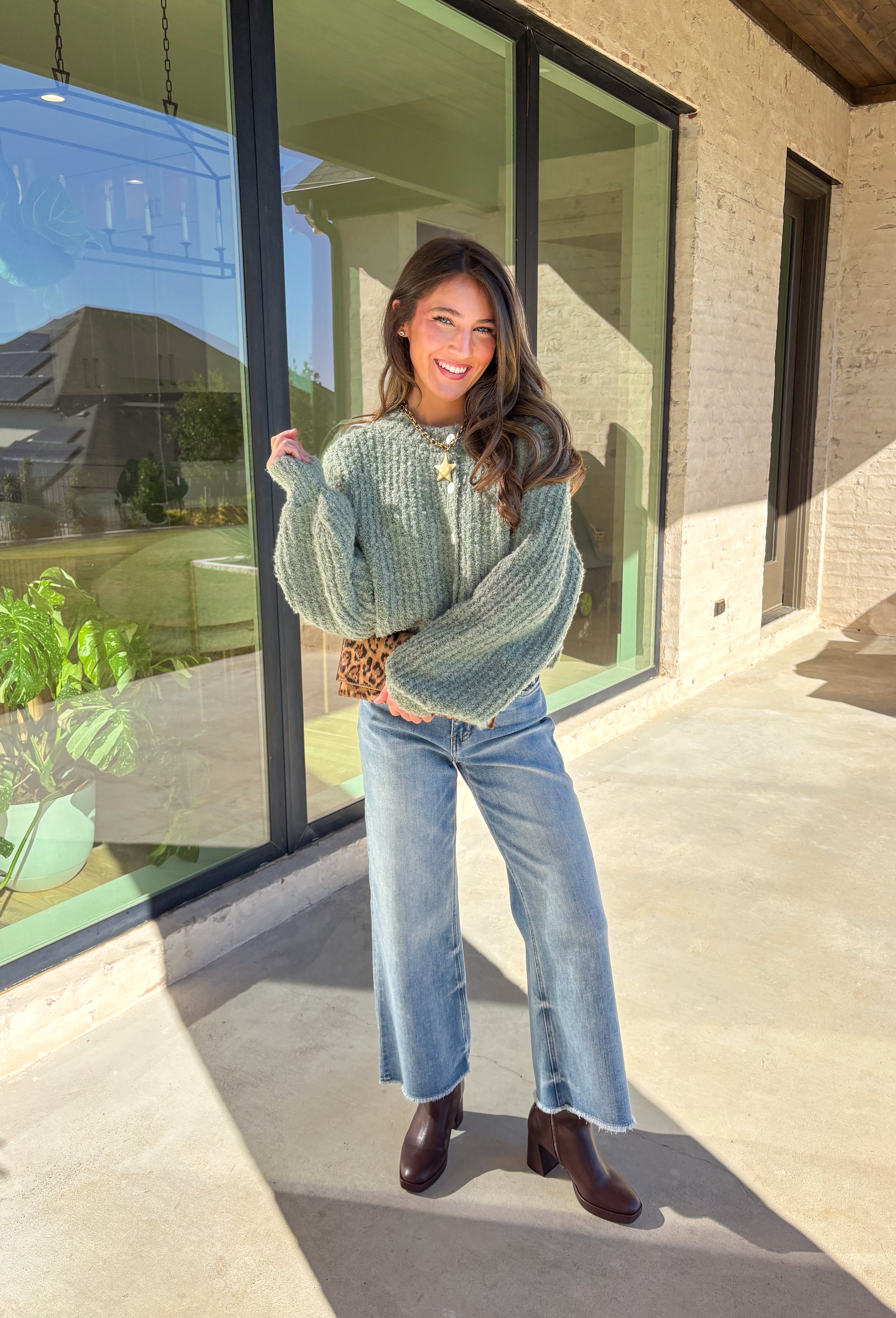 Soft, cozy, and perfectly cropped—this sage green cardigan by Double Zero is a closet must-have for the season. The button-down front and relaxed fit make it effortlessly versatile, while the ultra-soft fabric keeps it comfy for all-day wear. Ideal for layering over your favorite tanks or pairing with high-rise denim, this cozy cutie is ready for fall days and nights in.