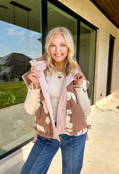 Say hello to your new favorite layering piece for fall! This brown ribbed vest features a vintage-inspired neutral floral print with soft light pink suede accents that run along the front for just the right pop of texture. With side ties, front pockets, and a classic button-down design, it’s equal parts cozy and charming.