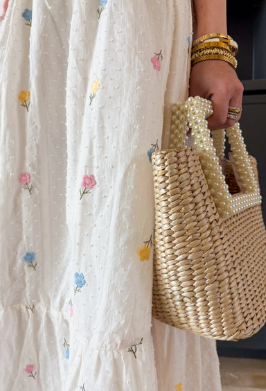 If happiness were a skirt, this would be it! This off white swiss dot midi skirt is sprinkled with the prettiest embroidered florals in butter yellow, light blue, light pink, and green — basically everything we love about spring wrapped into one easy, feminine piece. The textured swiss dot fabric adds soft dimension, while the colorful floral embroidery brings it to life. An elastic waistband keeps it comfortable and flattering, and the full lining makes it effortless to wear. 