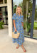 This blue striped midi dress is the perfect blend of classic and cheerful for summer! The blue stripe print creates a timeless foundation, while the yellow floral pattern adds a bright, sunny pop that instantly stands out. Designed with a collared neckline and button front closure, it has a polished feel that's easy to dress up or down. The adjustable drawstring waist creates a flattering silhouette, and side pockets make it even better. 
