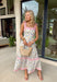 Fresh, colorful, and made for sunny days! This neutral tiered dress features a vibrant floral print with pops of pink, yellow, purple, blue, and green for a cheerful, eye-catching look. The flowy tiered silhouette adds beautiful movement, while the pink and white stripe trim throughout gives it an extra playful touch. The adjustable tie straps not only add a sweet detail but also allow for a customizable fit. Lightweight and fully lined, this dress is perfect for everything.