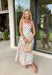 Fresh, colorful, and made for sunny days! This neutral tiered dress features a vibrant floral print with pops of pink, yellow, purple, blue, and green for a cheerful, eye-catching look. The flowy tiered silhouette adds beautiful movement, while the pink and white stripe trim throughout gives it an extra playful touch. The adjustable tie straps not only add a sweet detail but also allow for a customizable fit. Lightweight and fully lined, this dress is perfect for everything.