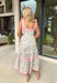 Fresh, colorful, and made for sunny days! This neutral tiered dress features a vibrant floral print with pops of pink, yellow, purple, blue, and green for a cheerful, eye-catching look. The flowy tiered silhouette adds beautiful movement, while the pink and white stripe trim throughout gives it an extra playful touch. The adjustable tie straps not only add a sweet detail but also allow for a customizable fit. Lightweight and fully lined, this dress is perfect for everything.