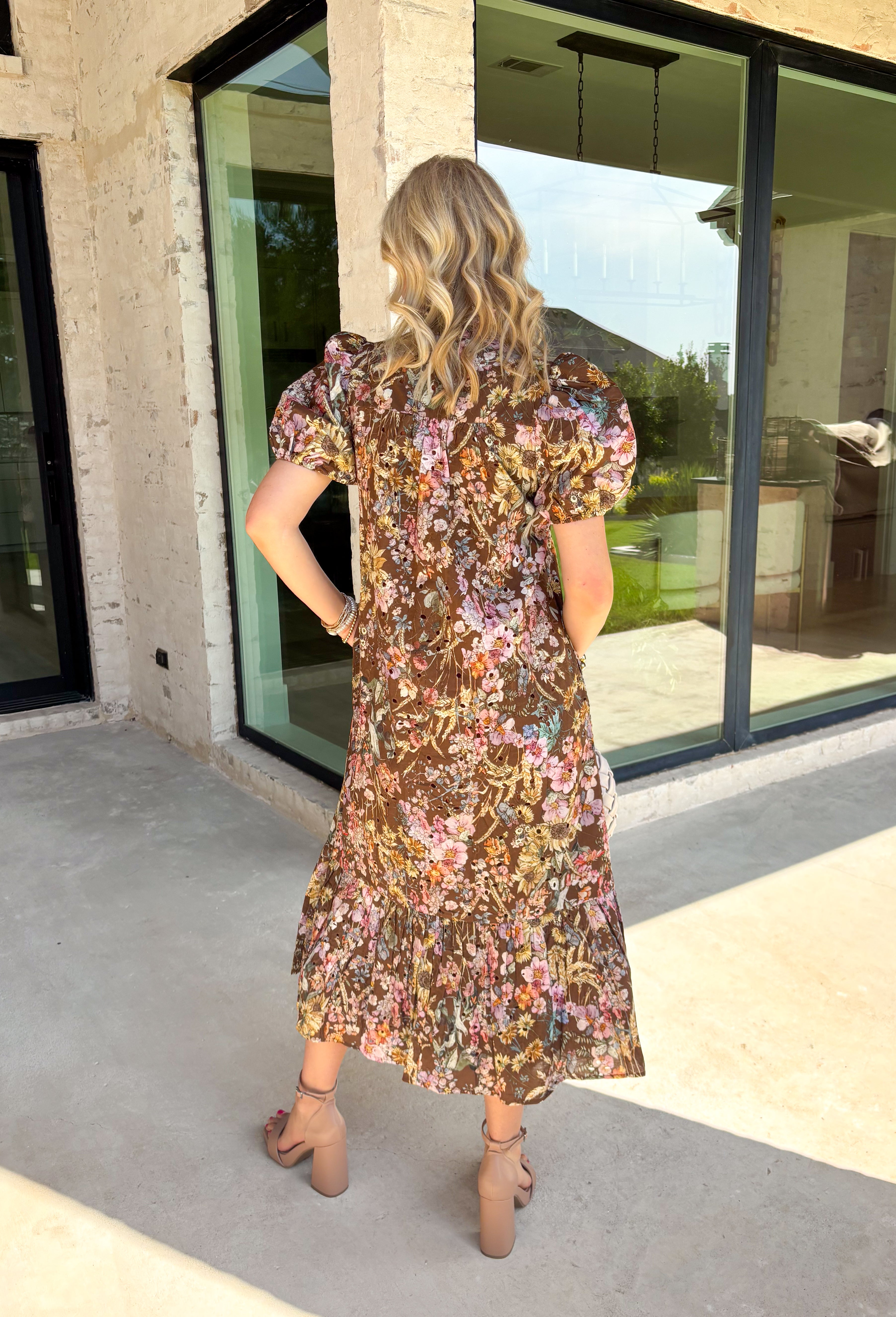 Fall florals have never looked so timeless! This beautiful brown midi dress features a delicate floral print with eyelet detailing that adds texture and charm to every look. The ruffled band collar and flattering v-neckline create an effortlessly feminine silhouette, while the button front brings a classic touch. Finished with short puff sleeves, side pockets, and a fully lined design, this dress is as practical as it is beautiful.