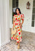 Bright blooms and easy details make this neutral short sleeve midi dress by Entro a spring favorite. Featuring a bold tulip floral print with vibrant pops of red, green, and orange, it brings cheerful color to a soft, wearable base. Puff sleeves add a feminine touch, while the front zipper closure gives it a modern, effortless feel. An elastic waist creates a flattering fit, and the full lining keeps it comfortable all day long. This is the kind of dress that does all the work—just add sunshine.