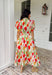 Bright blooms and easy details make this neutral short sleeve midi dress by Entro a spring favorite. Featuring a bold tulip floral print with vibrant pops of red, green, and orange, it brings cheerful color to a soft, wearable base. Puff sleeves add a feminine touch, while the front zipper closure gives it a modern, effortless feel. An elastic waist creates a flattering fit, and the full lining keeps it comfortable all day long. This is the kind of dress that does all the work—just add sunshine.